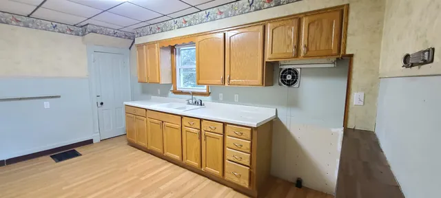 a kitchen with a sink stove and cabinets