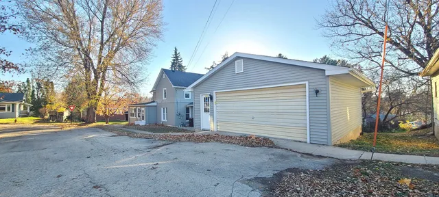 a view of a house with a yard and garage