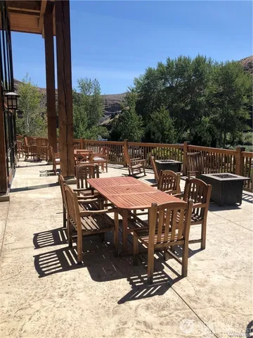 a view of a patio with a table chairs and backyard