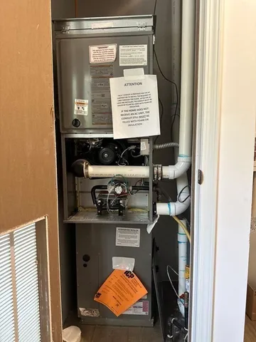 a view of a hallway with wooden floor and closet