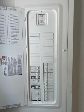 a view of a house with backyard and a tree