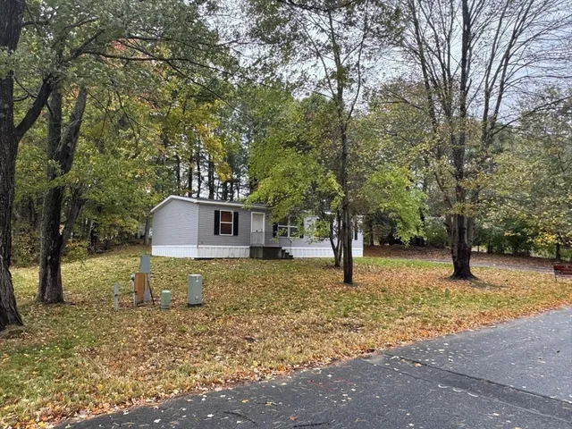 a house that has a tree in front of it