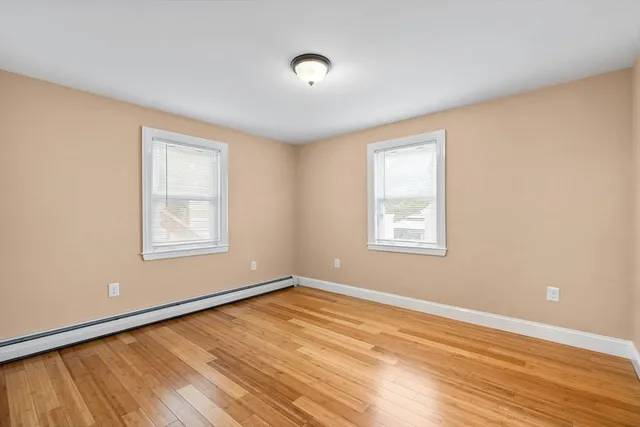 a view of a room with wooden floor and window