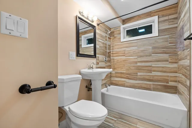 a bathroom with a sink a toilet and a bathtub