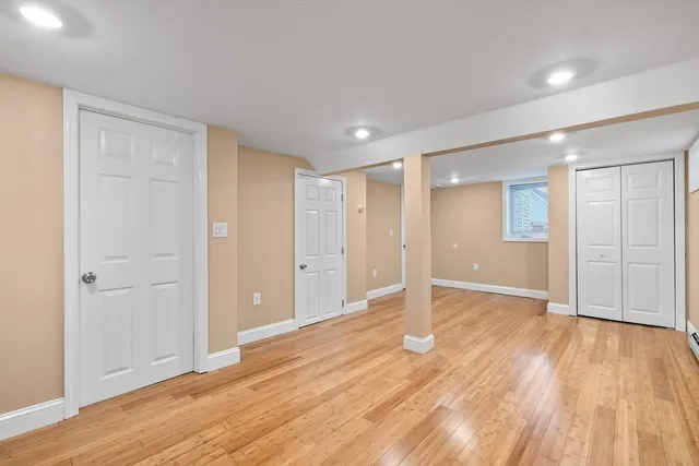 a view of an empty room with wooden floor