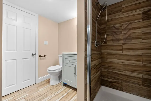 a bathroom with a toilet and a shower