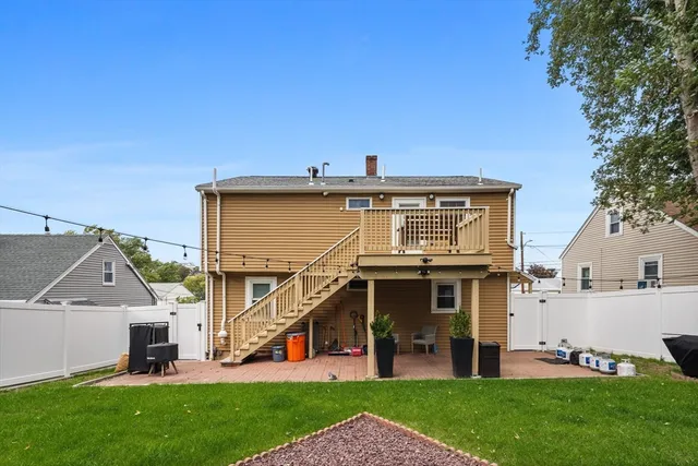 a view of a house with a yard and deck