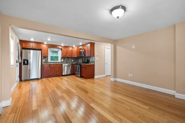 a view of a kitchen with a sink and a refrigerator