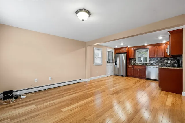 a view of kitchen with refrigerator and microwave