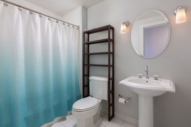 a bathroom with a sink toilet and a mirror