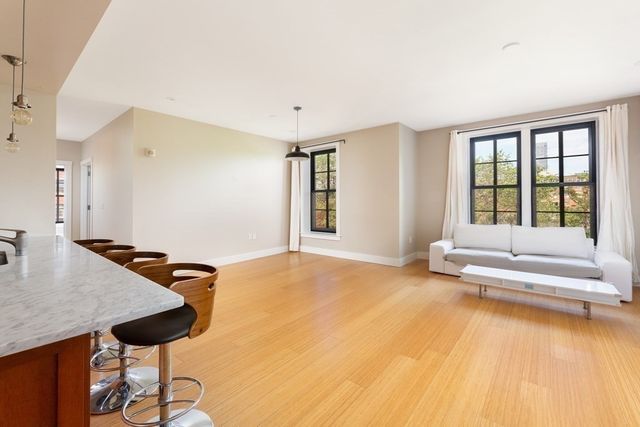 a spacious bedroom with a bed and a table with flat screen tv
