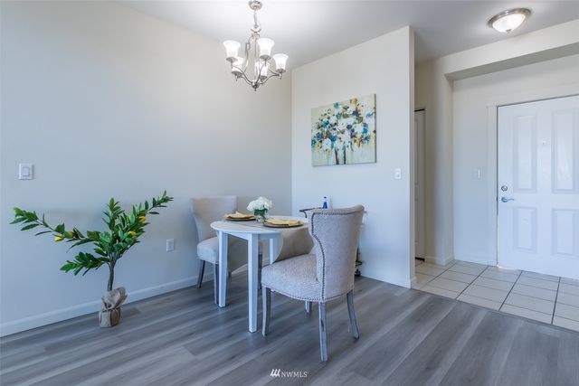 a view of a dining room with furniture wooden floor and a chandelier