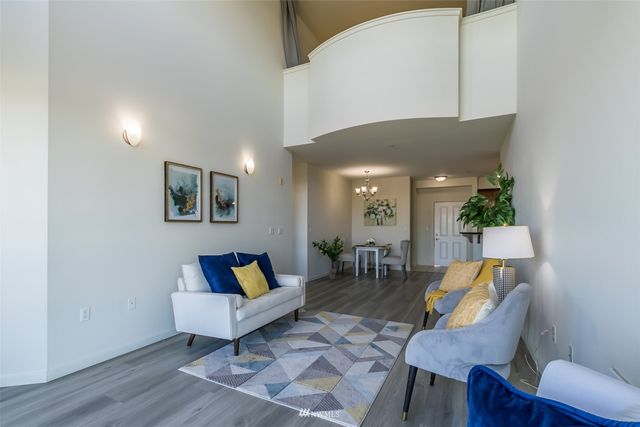 a living room with furniture and a painting