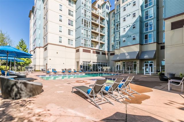 a view of a swimming pool with outdoor seating