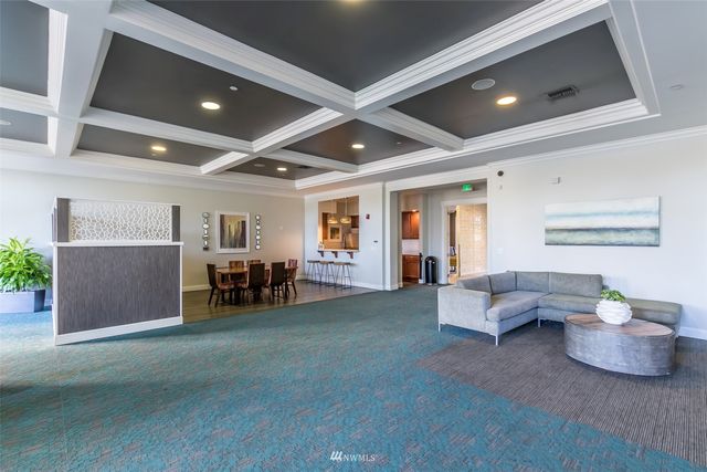 a living room with furniture and dining room