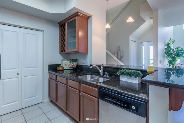 a kitchen with granite countertop a sink and cabinets