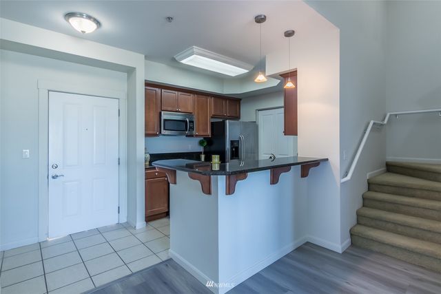 a view of kitchen with furniture and wooden floor