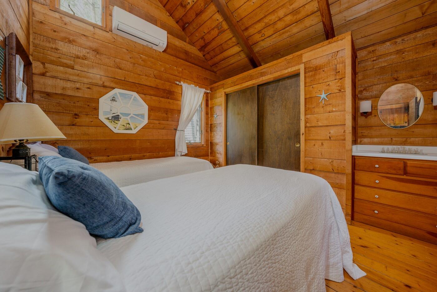 1780 Route 6, Unit D3 Wellfleet, MA 02667 - Photo 15 of 25 a bedroom with a bed and a dresser next to a window
