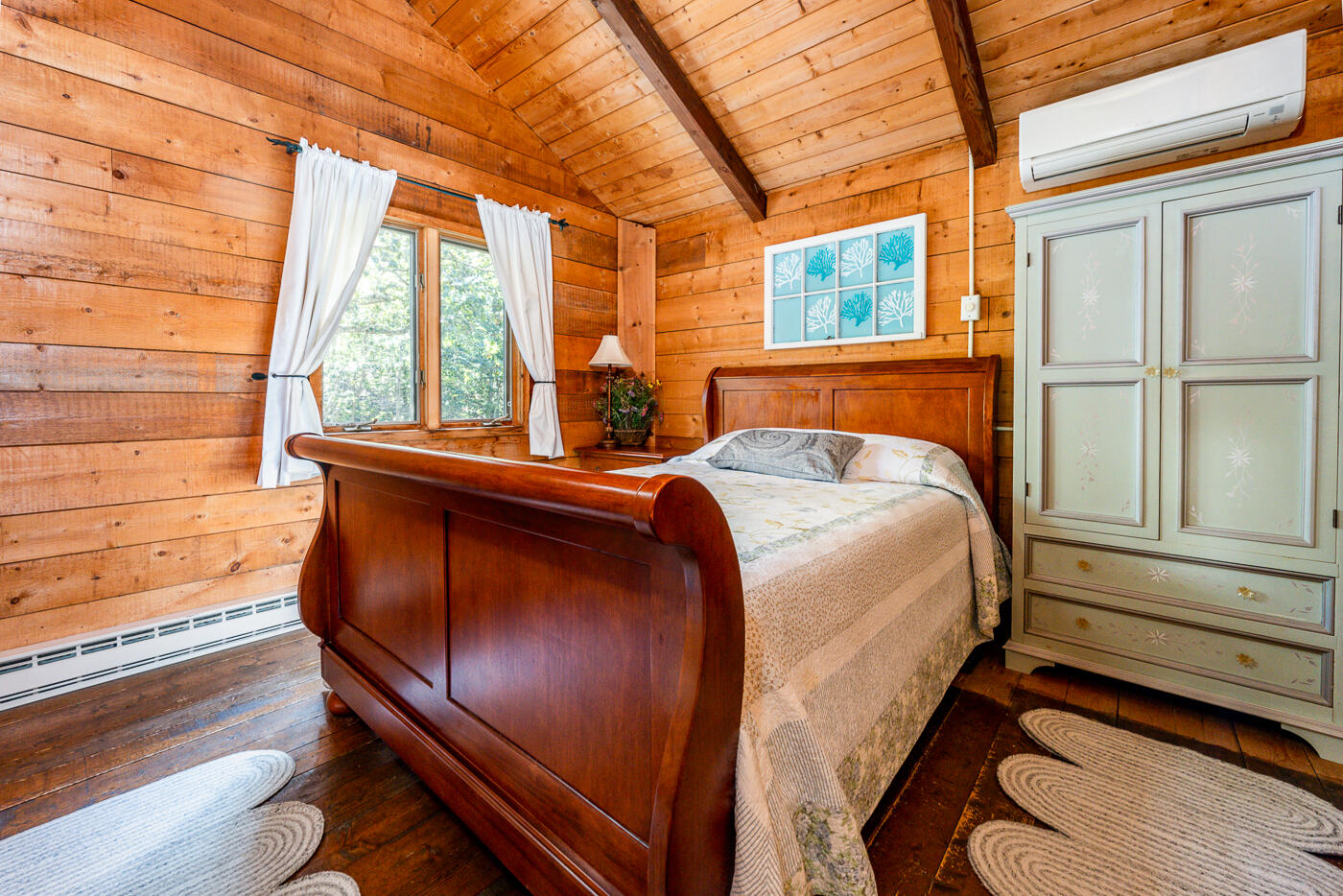 1780 Route 6, Unit D3 Wellfleet, MA 02667 - Photo 18 of 25 a bed sitting in a bedroom next to a window