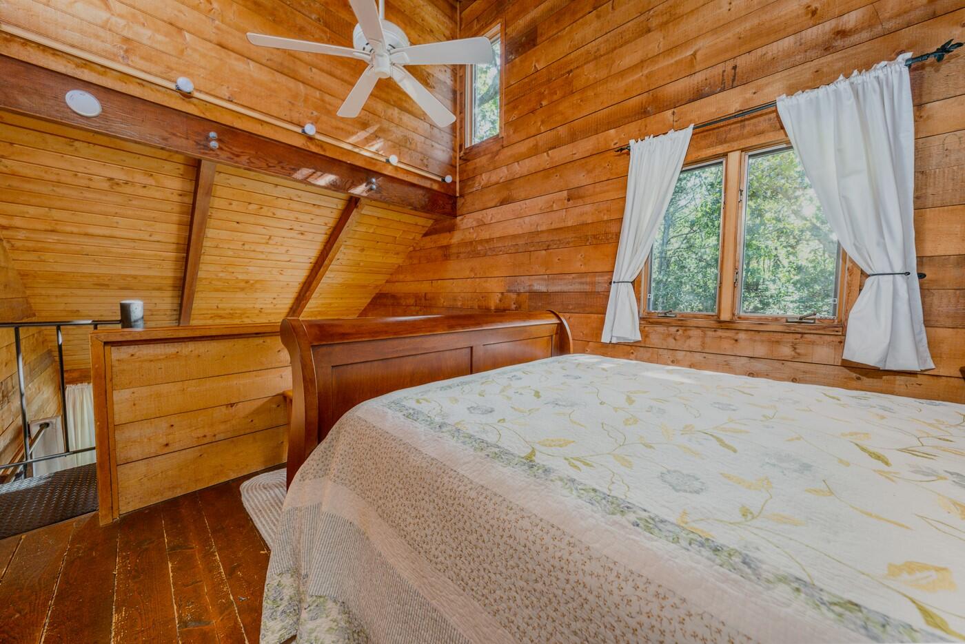 1780 Route 6, Unit D3 Wellfleet, MA 02667 - Photo 19 of 25 a view of a room with wooden floor and iron stairs