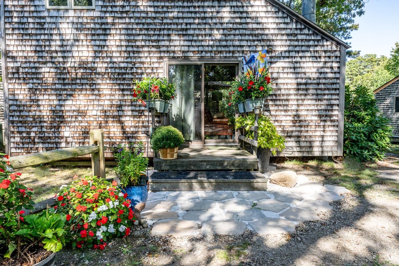 1780 Route 6, Unit D3 Wellfleet, MA 02667 - Photo 3 of 25 a view of a house with potted plants