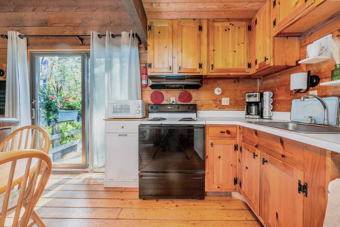 1780 Route 6, Unit D3 Wellfleet, MA 02667 - Photo 6 of 25 a kitchen with stainless steel appliances granite countertop a stove a sink and a refrigerator
