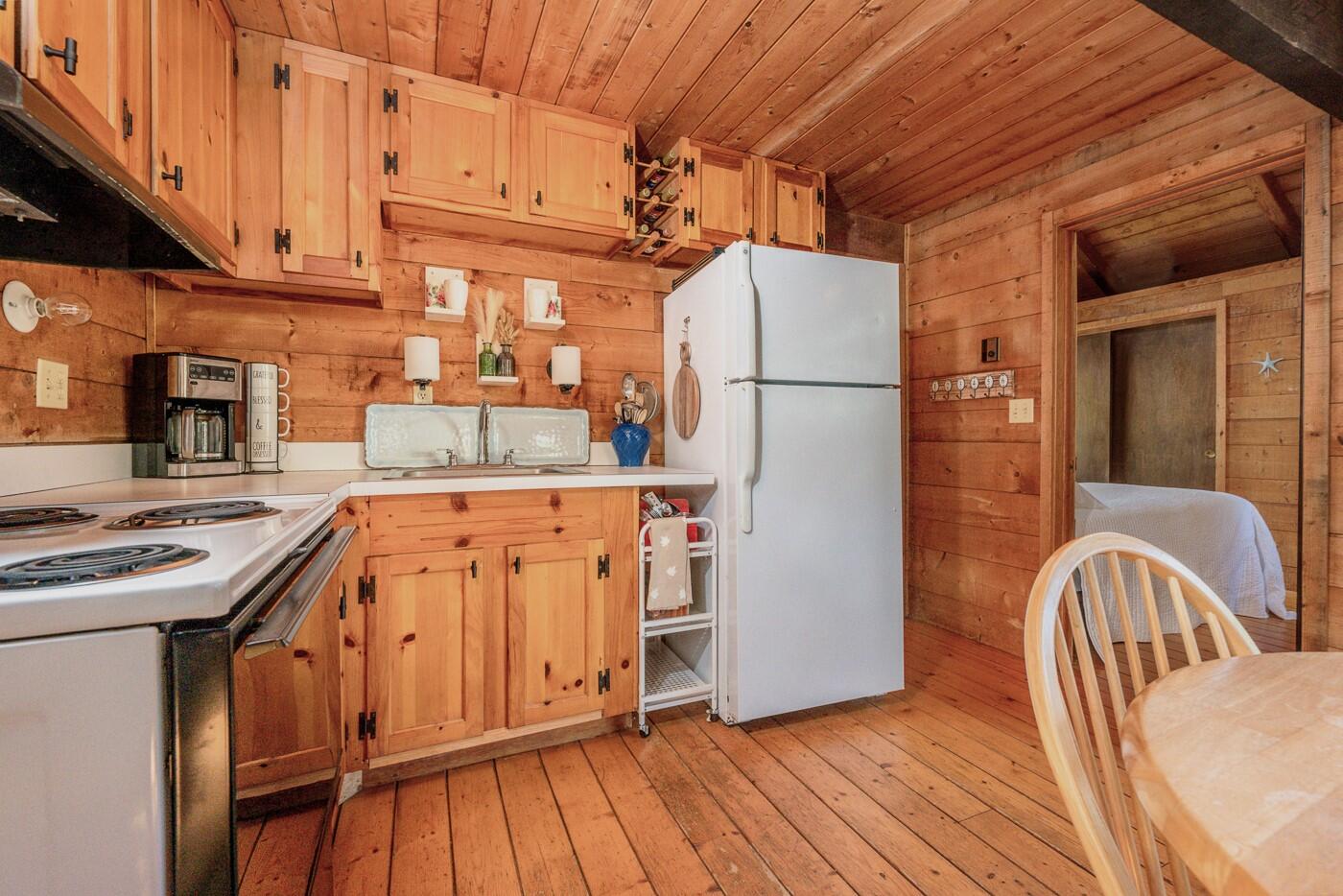 1780 Route 6, Unit D3 Wellfleet, MA 02667 - Photo 8 of 25 a kitchen with a refrigerator and a stove top oven