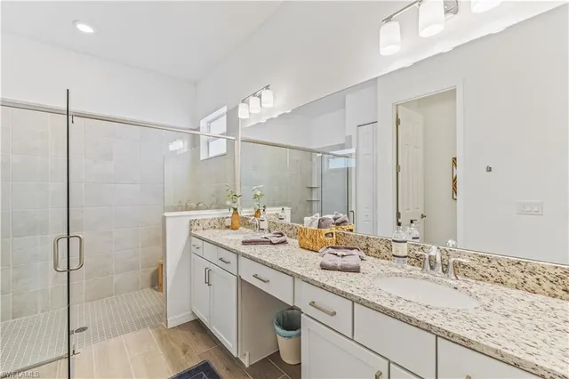 a bathroom with a granite countertop sink mirror and double