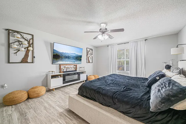 a bedroom with a bed and a flat screen tv