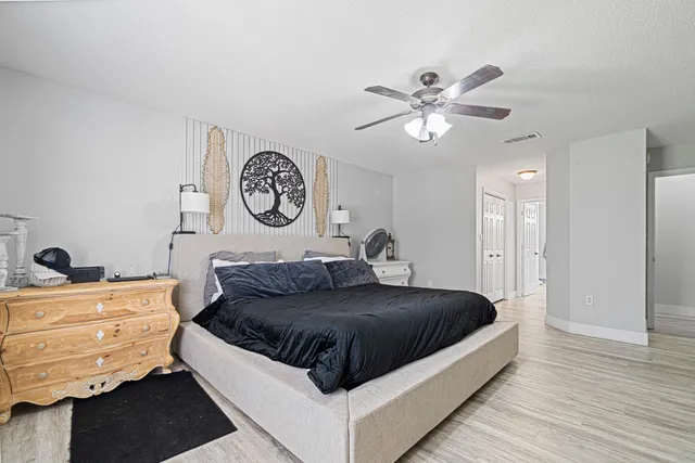 a living room with a bed and a chandelier