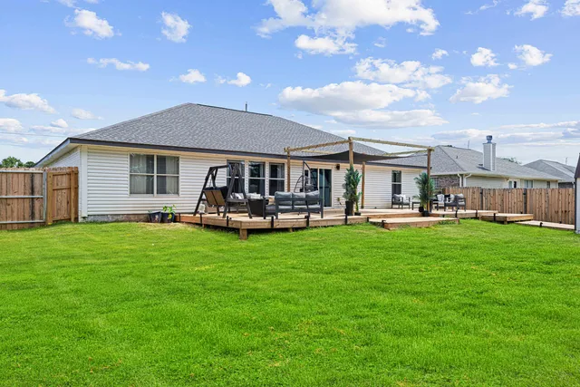 a backyard of a house with yard table and chairs