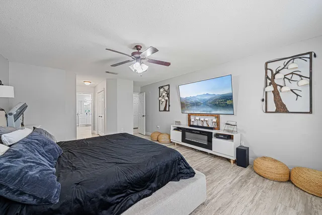 a spacious bedroom with a bed and dresser