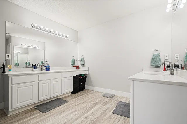 a spacious bathroom with a sink and a mirror