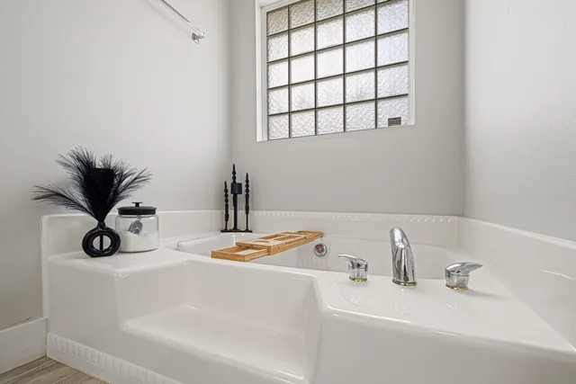 a bathroom with a sink and a window