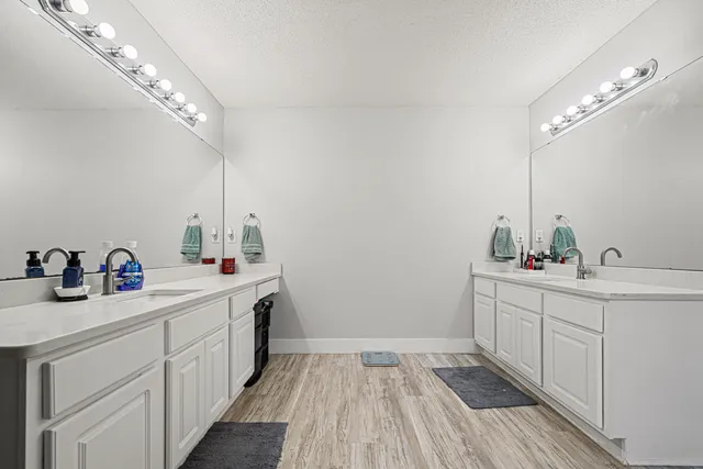 a kitchen with a sink cabinets and wooden floor