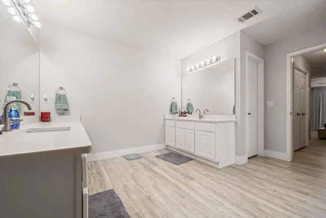 a bathroom with a sink double vanity and a mirror
