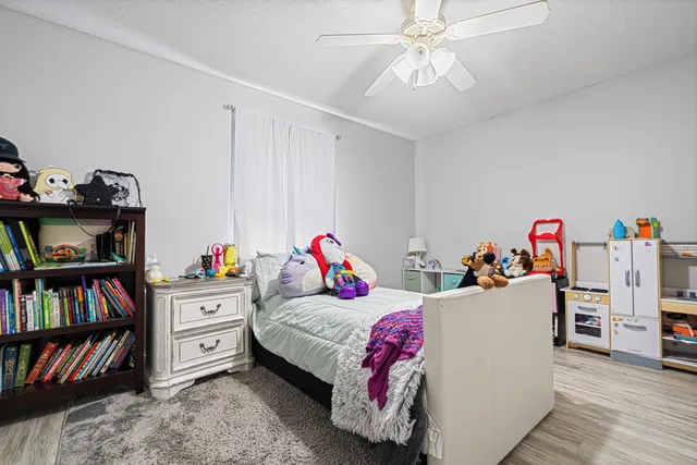 a bedroom with furniture and a book shelf