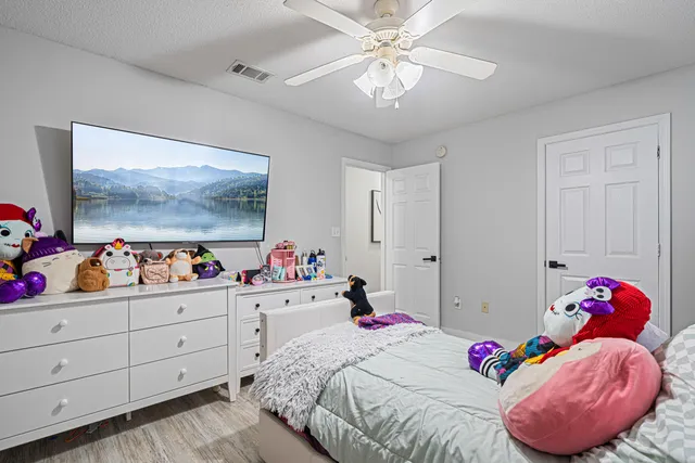 a bed room with two beds and a chandelier