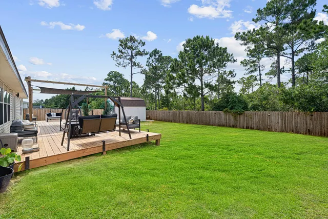 a view of a backyard with sitting area