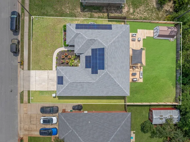 an aerial view of a house with a swimming pool