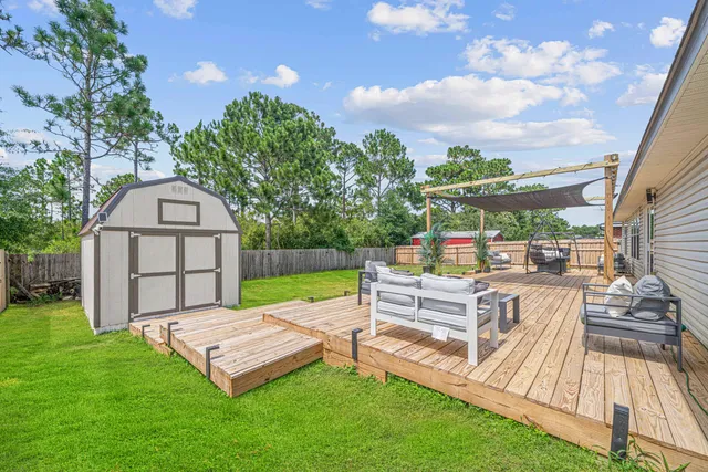 a view of a backyard with swimming pool