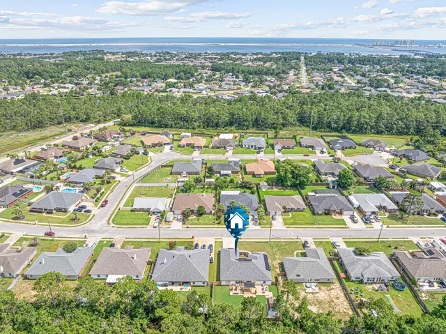 an aerial view of residential houses with outdoor space and river view