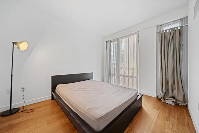 a bedroom with a bed and a window