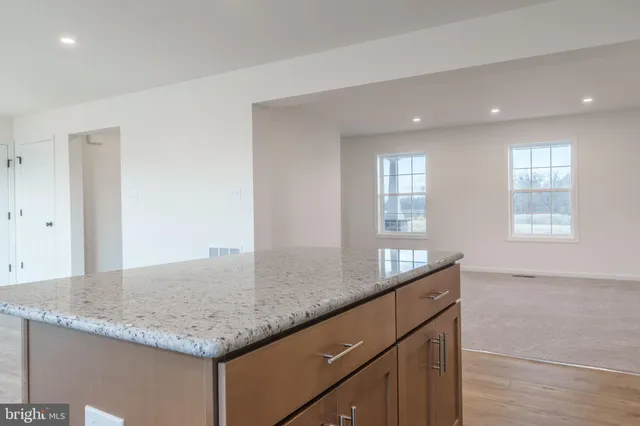 a kitchen with granite countertop kitchen island a sink appliances and a counter space