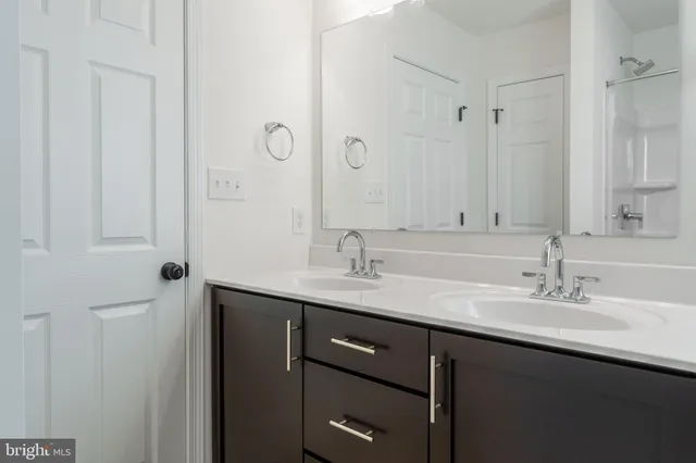 a bathroom with a sink double vanity and a mirror