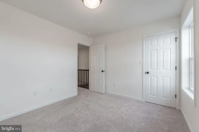 a view of an empty room and closet area