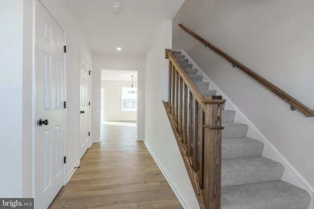 a view of a hallway with wooden floor and entryway