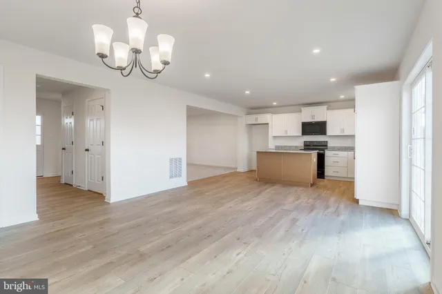 a view of a kitchen with a sink and wooden floor