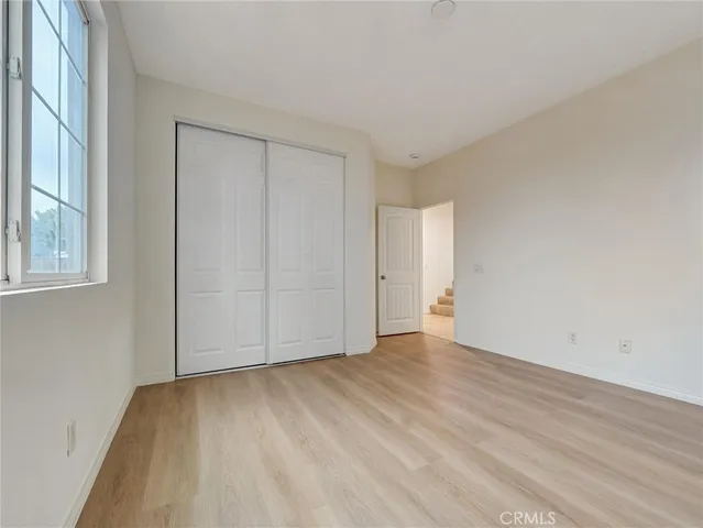 a spacious bedroom with bed and a chandelier