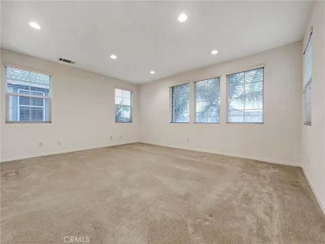 a spacious bathroom with a tub shower and a mirror